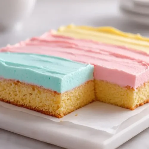 pastel frosted sheet cake with soft vanilla base and smooth pink blue yellow buttercream layers